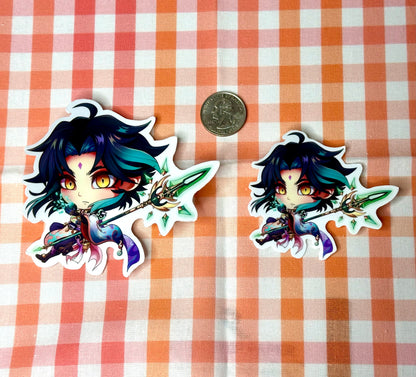 Comparison of chibi Xiao sticker, large and small, compared to a quarter.