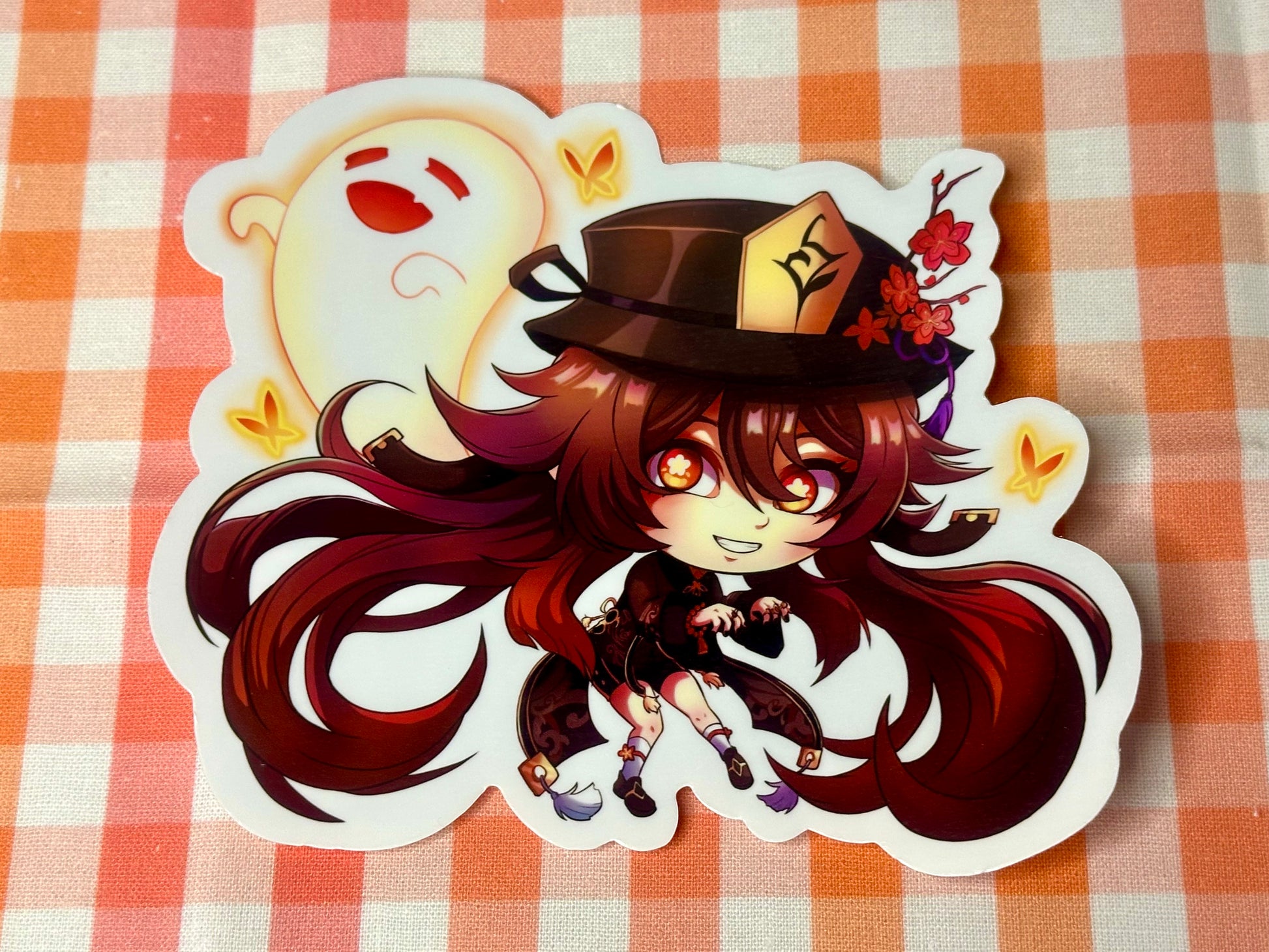 Close up of chibi sticker of Genshin Impact's Hu Tao. 