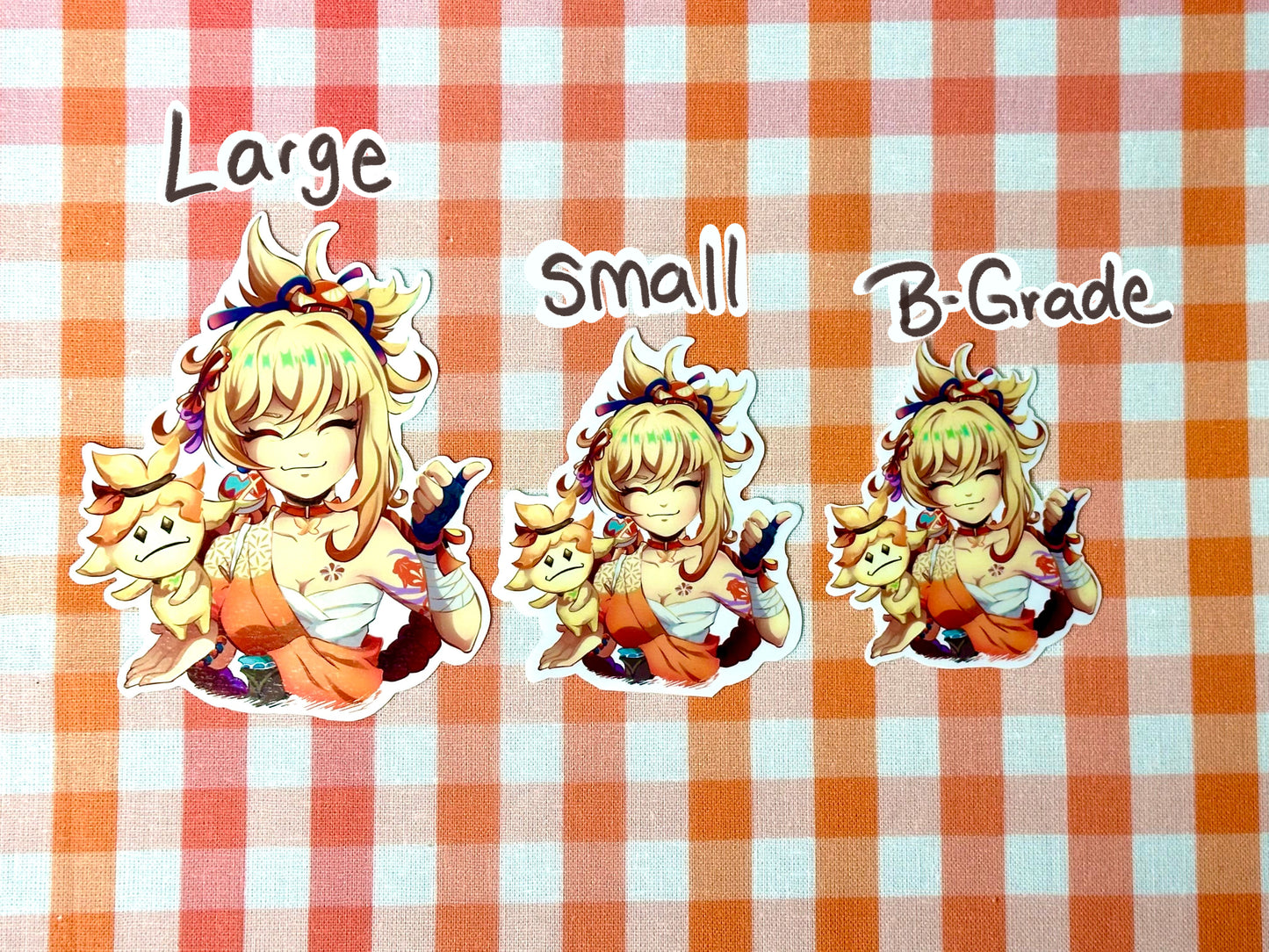 Different sizes of my Yoimiya emote sticker. Large, small, and B-grade. 